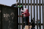 punjabis crossing mexico border, punjabis crossing US mexico border, video clip shows punjabi women children crossing border fence into u s, Mexico border